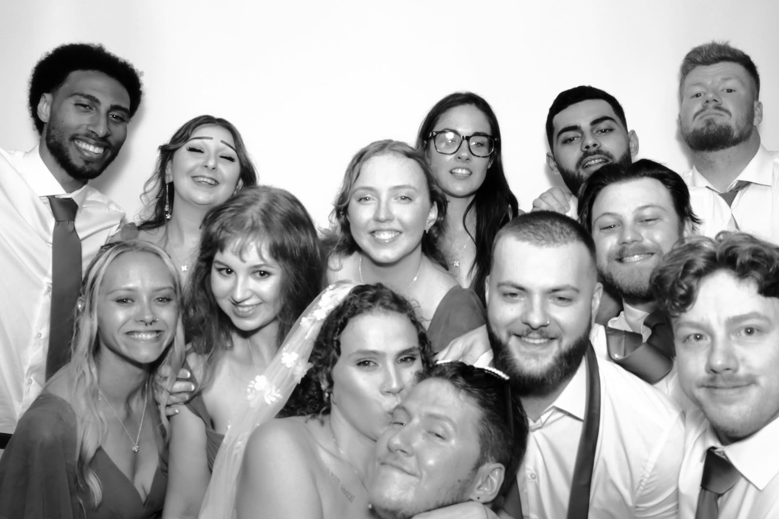 A dozen guests pressed into one frame, laughing