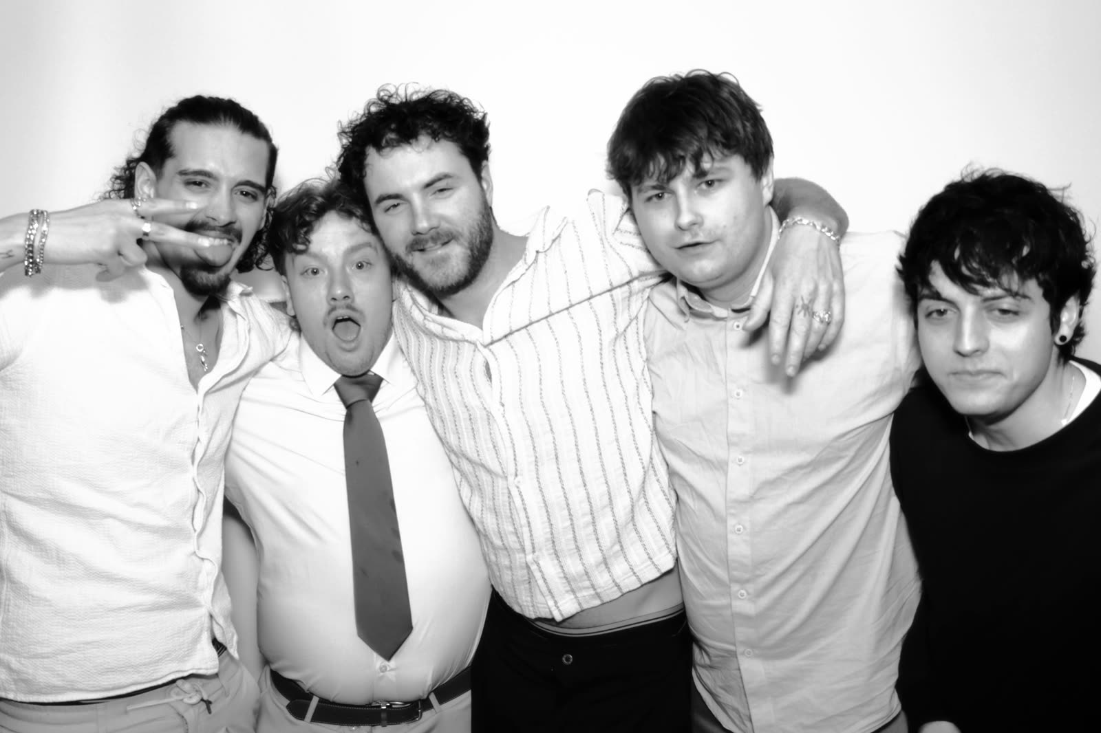 Five friends pulling faces at the camera