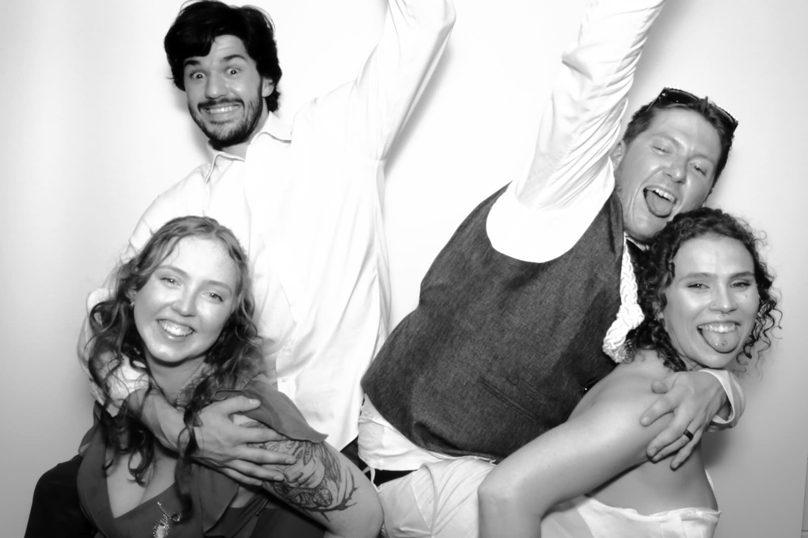 A guest leaping behind a group mid-frame