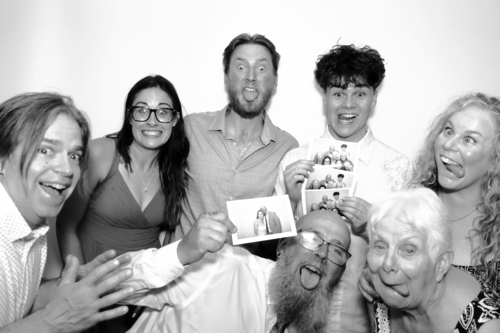 Three generations holding a freshly printed photo